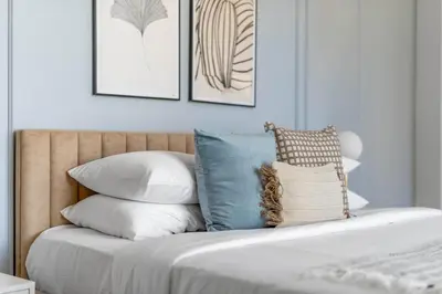 a bed with a bunch of pillows on it at GuestReady - Seaview residence in Dubai Marina in Dubai