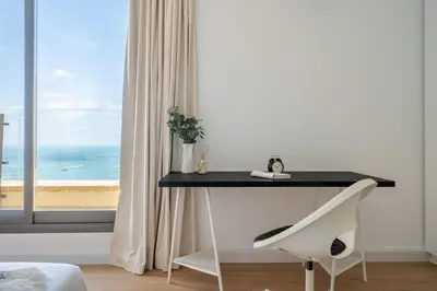 a desk in a room with a view of the ocean at GuestReady - Seaview residence in Dubai Marina in Dubai