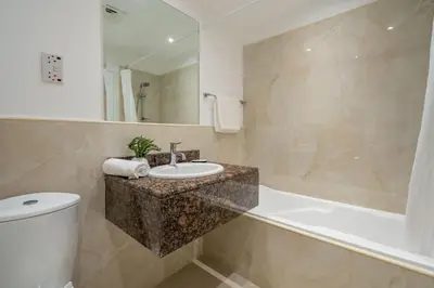 a bathroom with a sink and a tub and a toilet at GuestReady - Seaview residence in Dubai Marina in Dubai