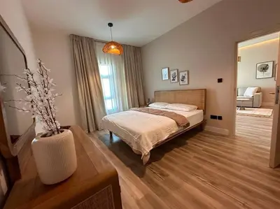 a bedroom with a bed and a vase on a table at Modern-Chic 1BR in The Greens - Central Dubai in Dubai
