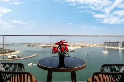 a table with a vase of flowers on top of a balcony at *Private Beach* Best Ocean View Emaar BeachFront in Dubai