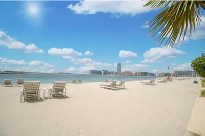 a group of chairs on a beach with the ocean at *Private Beach* Best Ocean View Emaar BeachFront in Dubai