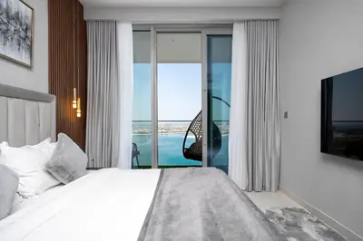 a bedroom with a bed and a view of the ocean at *Private Beach* Best Ocean View Emaar BeachFront in Dubai