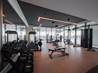 a gym with many treadmills and chairs in a building at Emaar Beachfront Beach Vista 3bdr apartment in Dubai