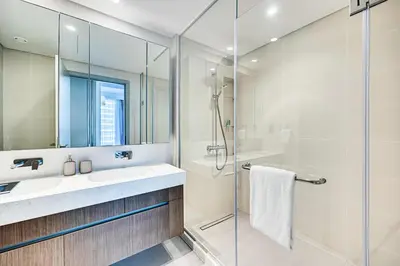 a bathroom with a sink and a shower at Phenomenal 2BD with the beach in Dubai
