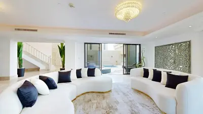 a living room with white couches and blue pillows at Huge Penthouse with yacht included and private pool!!! in Dubai