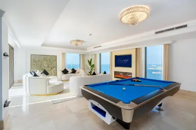 a living room with a pool table in it at Huge Penthouse with yacht included and private pool!!! in Dubai