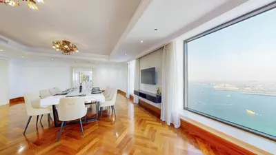 a dining room with a table and chairs and a large window at Huge Penthouse with yacht included and private pool!!! in Dubai