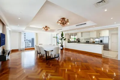 a kitchen and dining room with a table and chairs at Huge Penthouse with yacht included and private pool!!! in Dubai