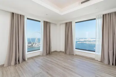 an empty room with large windows with a view of the ocean at Huge Penthouse with yacht included and private pool!!! in Dubai