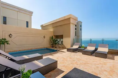 a patio with lounge chairs and a swimming pool at Huge Penthouse with yacht included and private pool!!! in Dubai