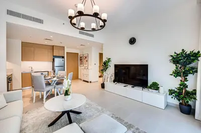 a living room with a couch and a table at Nice 1BD Apartment in Surf at Creek Beach in Dubai