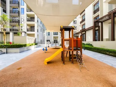 a playground in the courtyard of a building at Nice 1BD Apartment in Surf at Creek Beach in Dubai