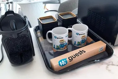 a tray with two coffee mugs on a desk at HiGuests - Step Into Heaven In This Lakeside Apartment in Dubai