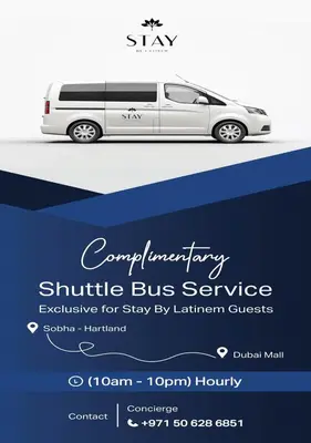 a white van with a shuttle bus service advertisement at STAY BY LATINEM Luxury 1BR Holiday Home CVR A413 near Burj Khalifa in Dubai