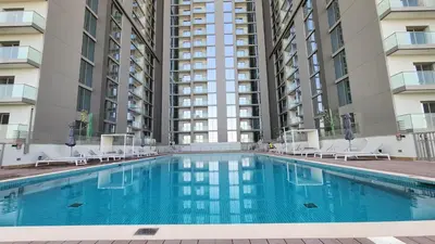 a swimming pool in front of two tall buildings at STAY BY LATINEM Luxury 1BR Holiday Home CVR A413 near Burj Khalifa in Dubai