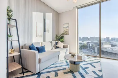 a living room with a couch and a table at STAY BY LATINEM Luxury 1BR Holiday Home CVR A413 near Burj Khalifa in Dubai