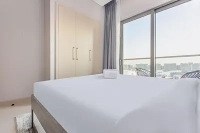 a bedroom with a white bed and a large window at STAY BY LATINEM Luxury 1BR Holiday Home CVR A413 near Burj Khalifa in Dubai