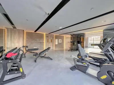 a gym with several treadmills and exercise bikes at Guestready - Grey Pearl with Big Balcony in Dubai