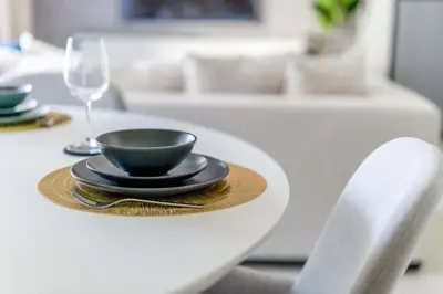 a table with a black bowl and a glass on it at GuestReady - Lux living with an infinity pool in Dubai