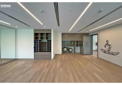 a large room with wooden floors and a large room with glass doors at bnbme - Chic 1BR Apt w Balcony Pool Gym Access Steps to Burj Khalifa & Dubai Mall in Dubai