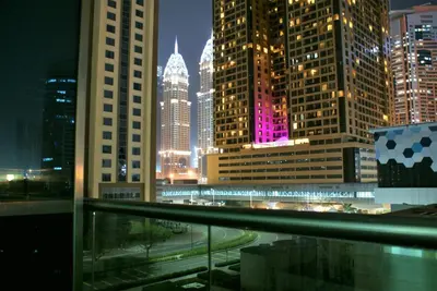 a view of a city skyline at night at Studio Apartment - Cozy, Very Accessible and so near to Train Station in Dubai