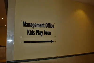 a sign on a wall that reads management office kids play area at Studio Apartment - Cozy, Very Accessible and so near to Train Station in Dubai