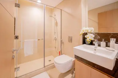 a bathroom with a toilet and a sink and a shower at Lux Golf Views 3 BR in Emirates Hills in Dubai