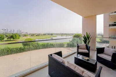 a living room with a view of a river at Lux Golf Views 3 BR in Emirates Hills in Dubai
