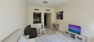 a living room with a couch and a flat screen tv at DRUVYA HOLIDAY HOMES, Bld DG083, Street No,3 Discovery Gardens, Close to The Gardens Metro 6 minutes walkable in Dubai
