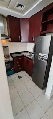 a kitchen with a refrigerator and a tile floor at DRUVYA HOLIDAY HOMES, Bld DG083, Street No,3 Discovery Gardens, Close to The Gardens Metro 6 minutes walkable in Dubai
