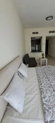 a white bed with two pillows in a room at DRUVYA HOLIDAY HOMES, Bld DG083, Street No,3 Discovery Gardens, Close to The Gardens Metro 6 minutes walkable in Dubai