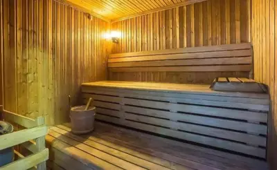 a wooden sauna with a tub and a bucket at Luxury 2 Bedroom Apartment in Dubai Marina & JBR Beach in Dubai