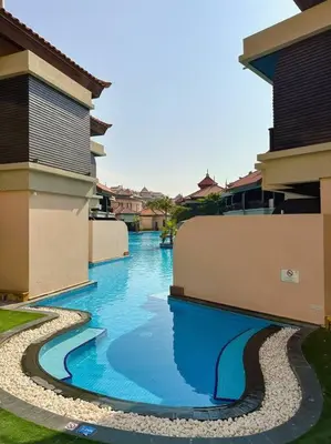 a river with blue water between two buildings at Family friendly apt at Palm in Dubai