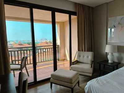 a hotel room with a bed and a balcony at Family friendly apt at Palm in Dubai