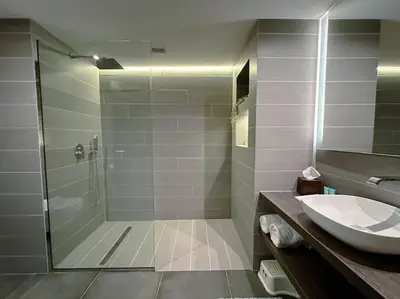 a bathroom with a shower and a sink at Family friendly apt at Palm in Dubai
