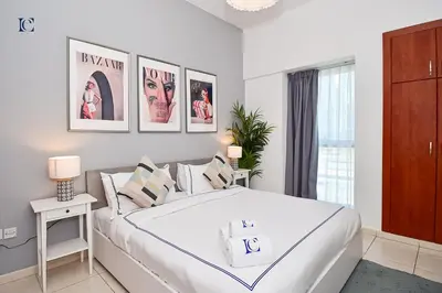 a bedroom with a large white bed in a room at Luxury Escapes - Stylish 1BR Apartment - Close to Metro in Dubai Marina - Cascade Tower in Dubai