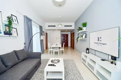 a living room with a couch and a table at Luxury Escapes - Stylish 1BR Apartment - Close to Metro in Dubai Marina - Cascade Tower in Dubai