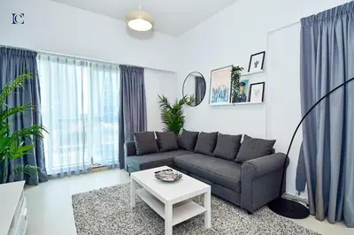 a living room with a couch and a table at Luxury Escapes - Stylish 1BR Apartment - Close to Metro in Dubai Marina - Cascade Tower in Dubai