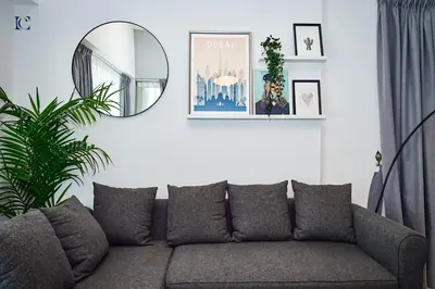 a living room with a couch and a mirror at Luxury Escapes - Stylish 1BR Apartment - Close to Metro in Dubai Marina - Cascade Tower in Dubai