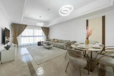 a living room with a table and a couch at Modern 1BR in Vibrant Fairmont North Residence - 90AB6 in Dubai