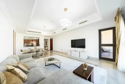 a living room with a couch and a tv at Modern 1BR in Vibrant Fairmont North Residence - 90AB6 in Dubai