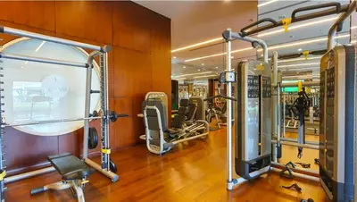 a gym with treadmills and exercise equipment at Modern 1BR in Vibrant Fairmont North Residence - 90AB6 in Dubai