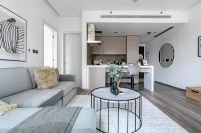 a living room with a couch and a table at GuestReady - Exquisite residence in Dubai Marina in Dubai