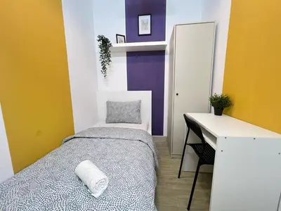a room with a bed and a desk and a mirror at Arch Partition Room Near Mall of the Emirates in Dubai