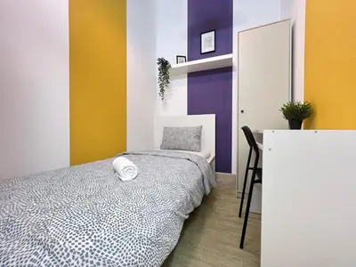 a bedroom with a bed and a desk with a mirror at Arch Partition Room Near Mall of the Emirates in Dubai