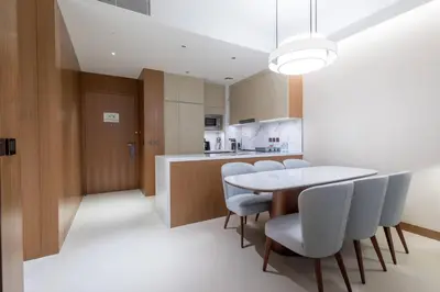 a kitchen and dining room with a table and chairs at Stunning Full Burj Khalifa View - The Address 2BR Luxury in Dubai