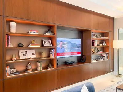 a living room with a tv on a wall at Stunning Full Burj Khalifa View - The Address 2BR Luxury in Dubai