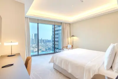 a bedroom with a white bed and a large window at Stunning Full Burj Khalifa View - The Address 2BR Luxury in Dubai