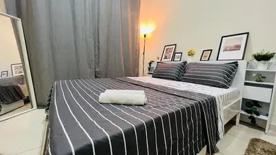 a bedroom with a bed with a towel on it at Beautiful Bedroom in Al Barsha Near Mashreq Metro in Dubai